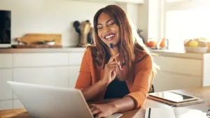 Setswana: Woman studying online. Adult matric home language course with laptop and notebook.