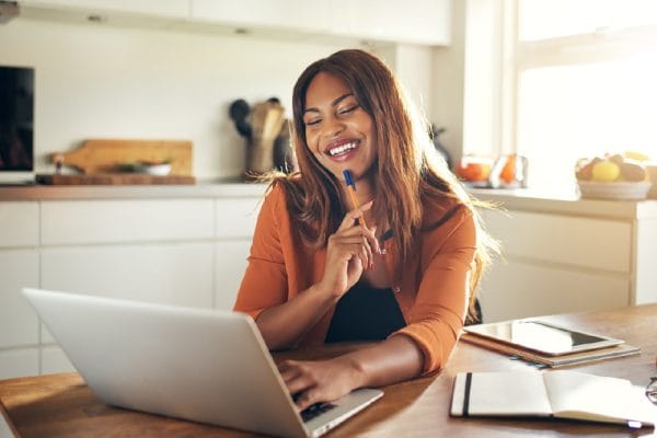 Setswana: Woman studying online. Adult matric home language course with laptop and notebook.