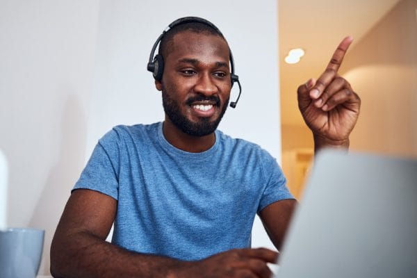 Office Administration student with headset at laptop. ICB Foundation Level course.