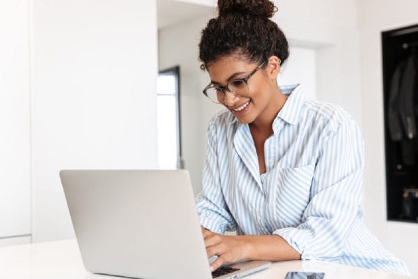 Office Administration student working on a laptop. Higher Certificate in Office Admin.