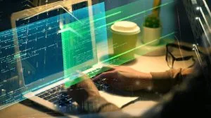 Ruby on Rails Full Stack Developer. Hands coding on laptop with code overlay. Software development, programming.
