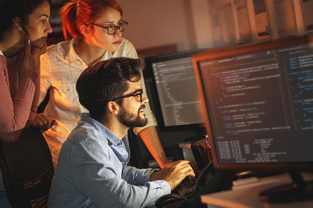 Machine learning specialist team working on code. Programming principles.