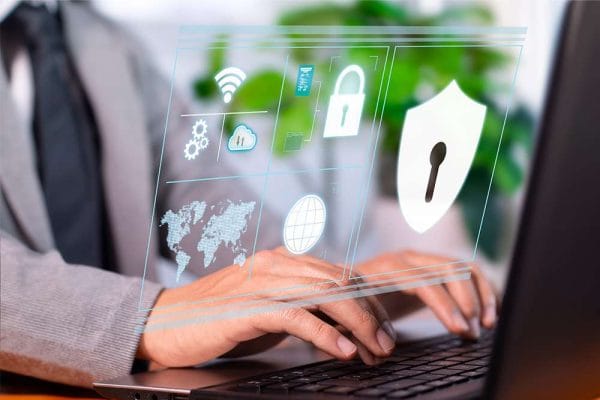 Certified Information Security Manager (CISM). Data security concept with shield, padlock, and world map icons on a laptop.