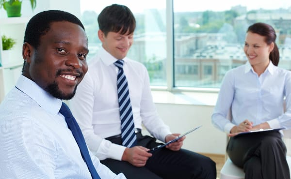 Diverse team with accredited qualifications. Smiling professionals in business attire.