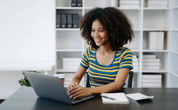 Short learning at home: Woman works on laptop. Online courses, education, and e-learning concept.