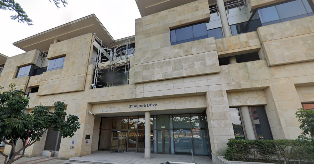 Schedule consultation at modern office building exterior, 21 Aurora Drive. Professional business center consultation.